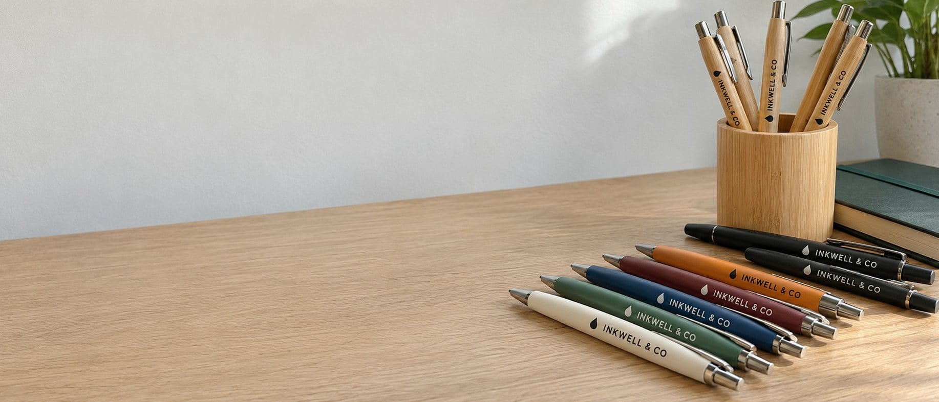 Custom printed logo pens in several colors on a desk